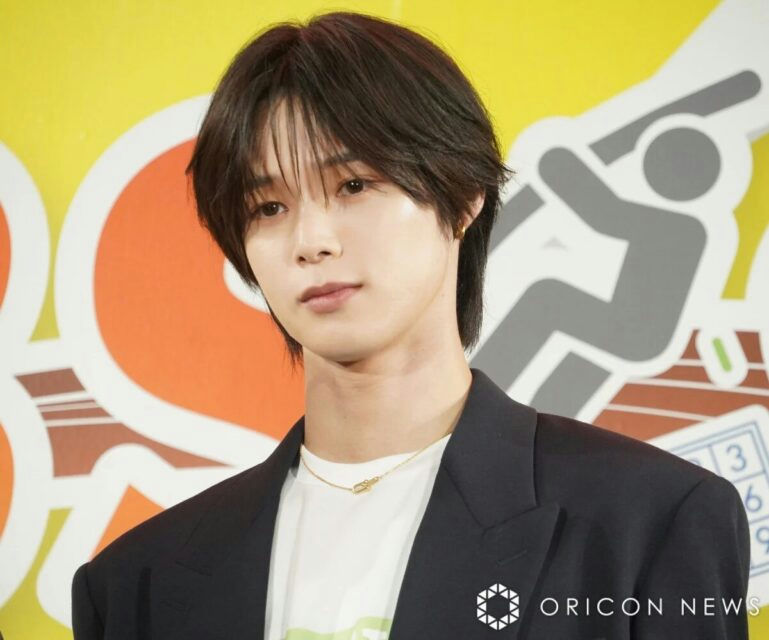 people-male-dark hair-black blazer-white t-shirt-gold necklace-Oricon News logo
