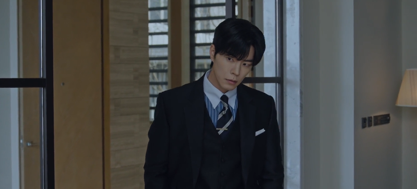 people-man-suit-A-formalwear-B-looking-down-C-indoors