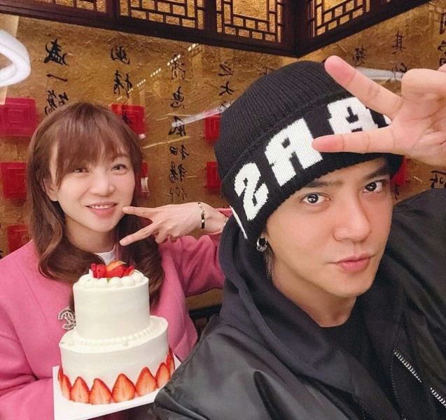 people-woman-smiling-man-making-peace-sign-cake-strawberry-birthday