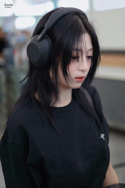 people-woman-headphones-black shirt-cross embroidery-black hair-street style