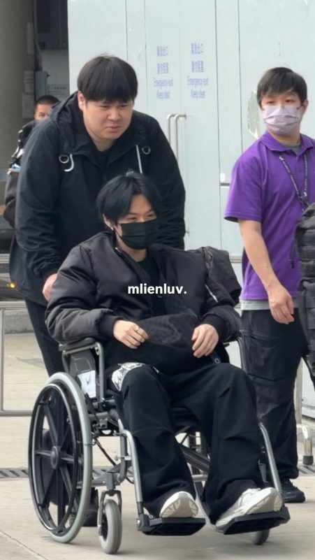 people-man in wheelchair-man pushing wheelchair-man in purple shirt-emergency exit signs