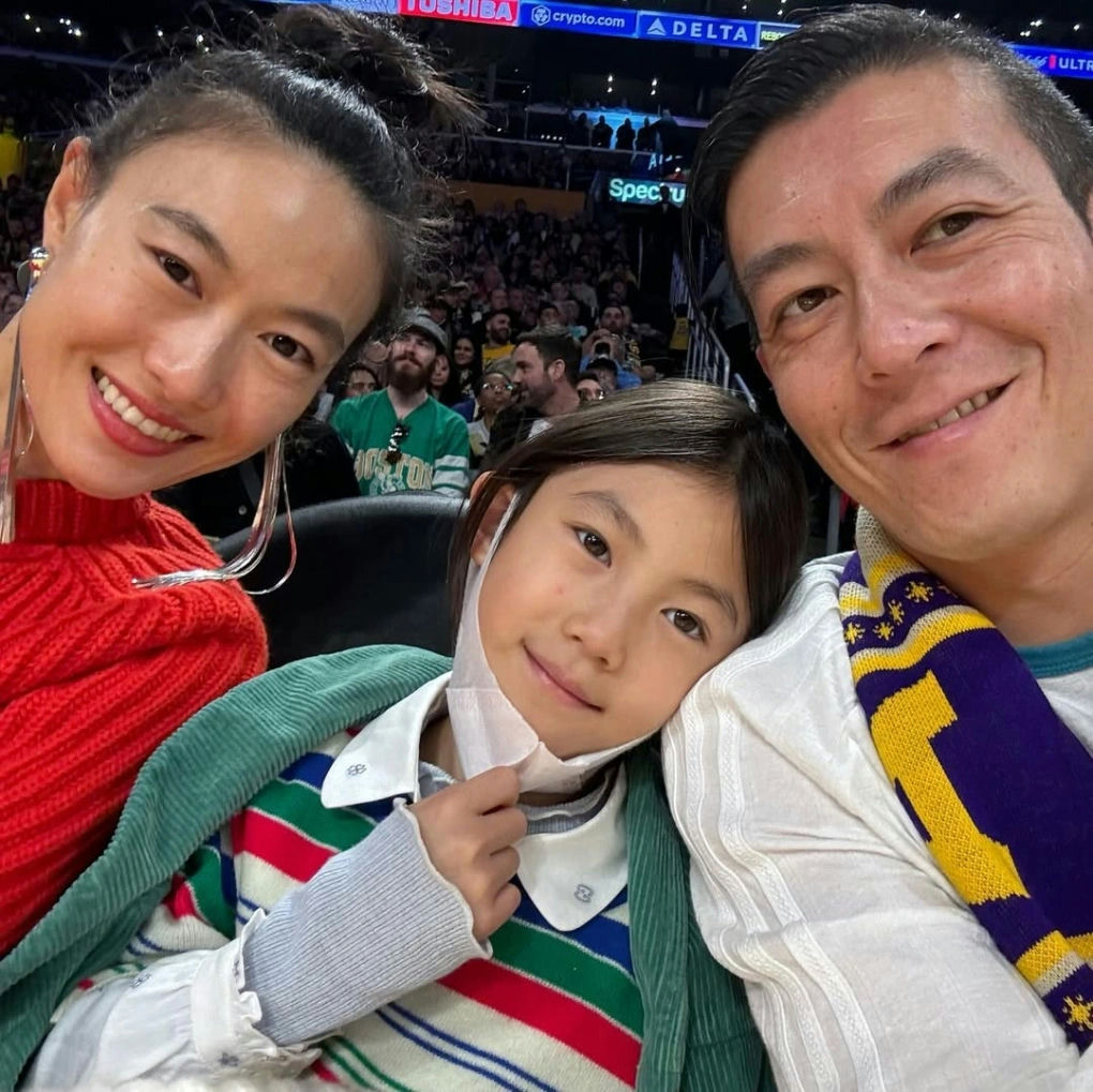 people-Three people-A-family selfie-A-sports event-B-woman smiling-B-child leaning on shoulder-C-man smiling-C-Lakers scarf