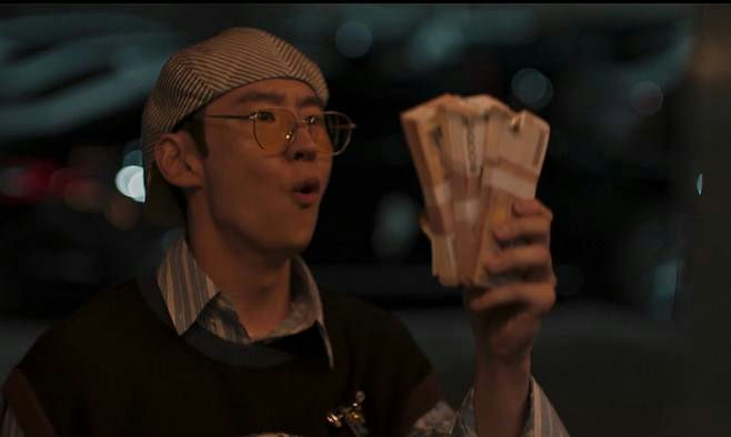 people-man-holding money-surprised expression-wearing glasses-wearing cap