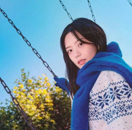 people-A-woman-A-swing-A-blue scarf-A-winter sweater-B-outdoor-C-bright sky