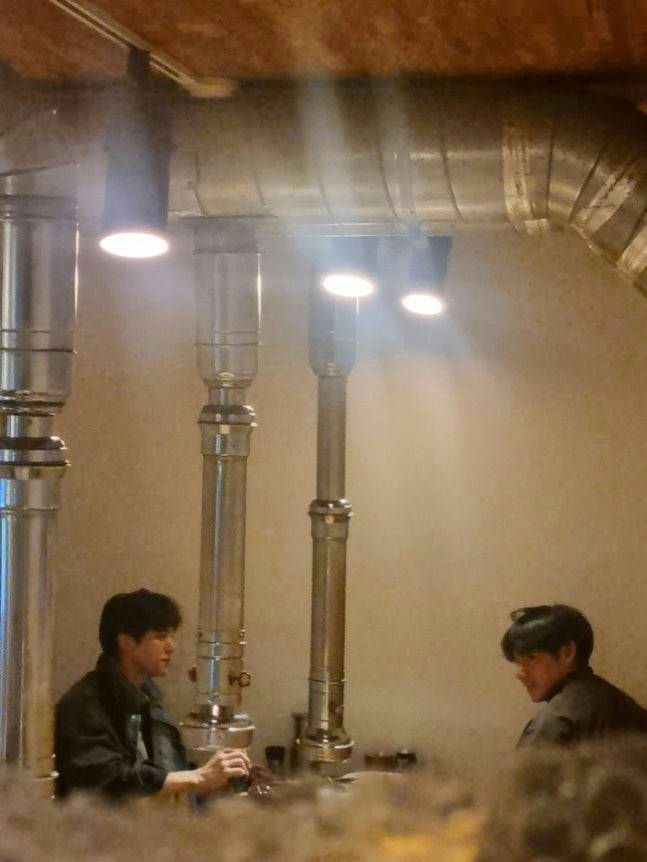 people-Two Young Men-A-Korean BBQ Restaurant-A-Exhaust Vents-A-Dim Lighting-B-Overhead Lights-C