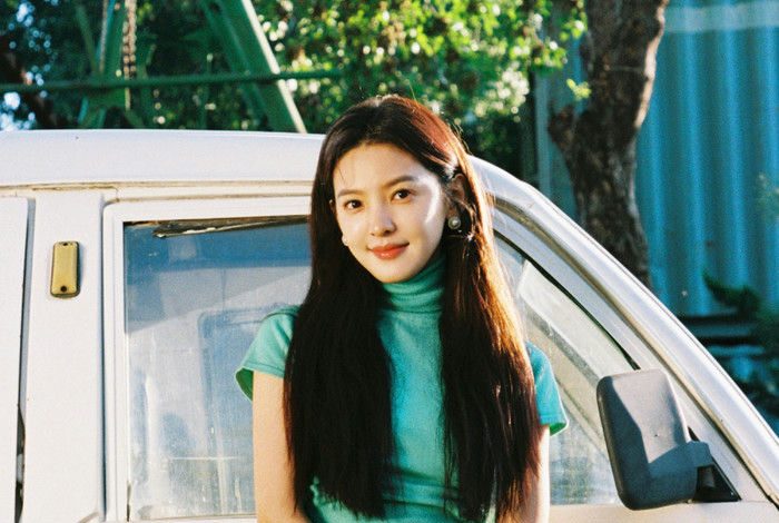 people-A-young woman-A-long dark hair-B-teal turtleneck top-C-plaid skirt
