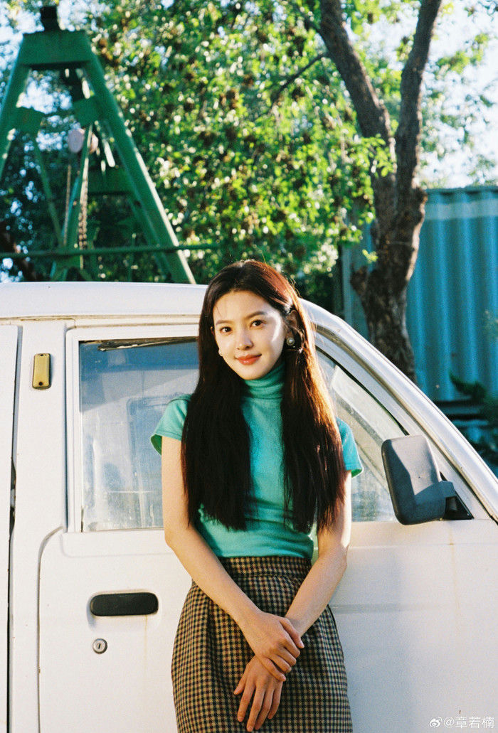 people-A-young woman-A-long dark hair-B-teal turtleneck top-C-plaid skirt