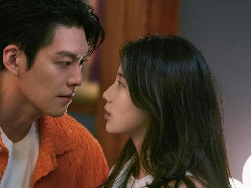 people-Man and woman-Intense gaze-Intimate moment-Orange sweater-Dark hair