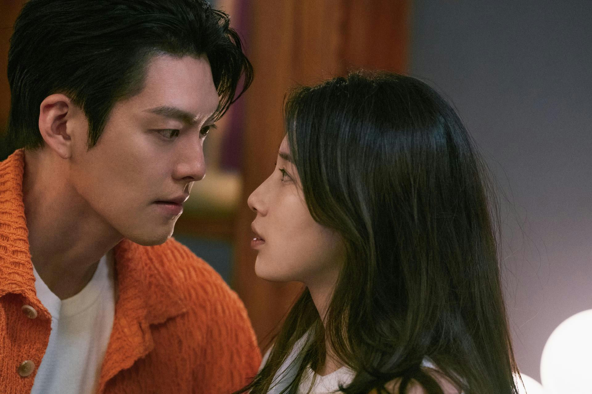 people-Man and woman-Intense gaze-Intimate moment-Orange sweater-Dark hair