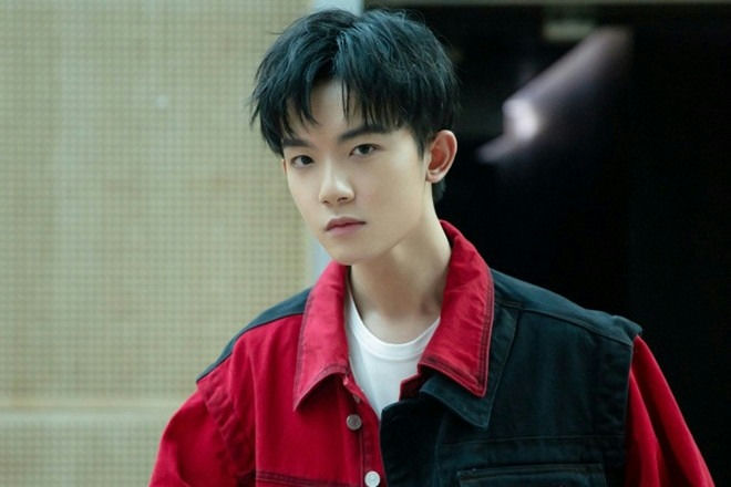 people-a young man-A-black hair-A-red and black jacket-A-serious expression