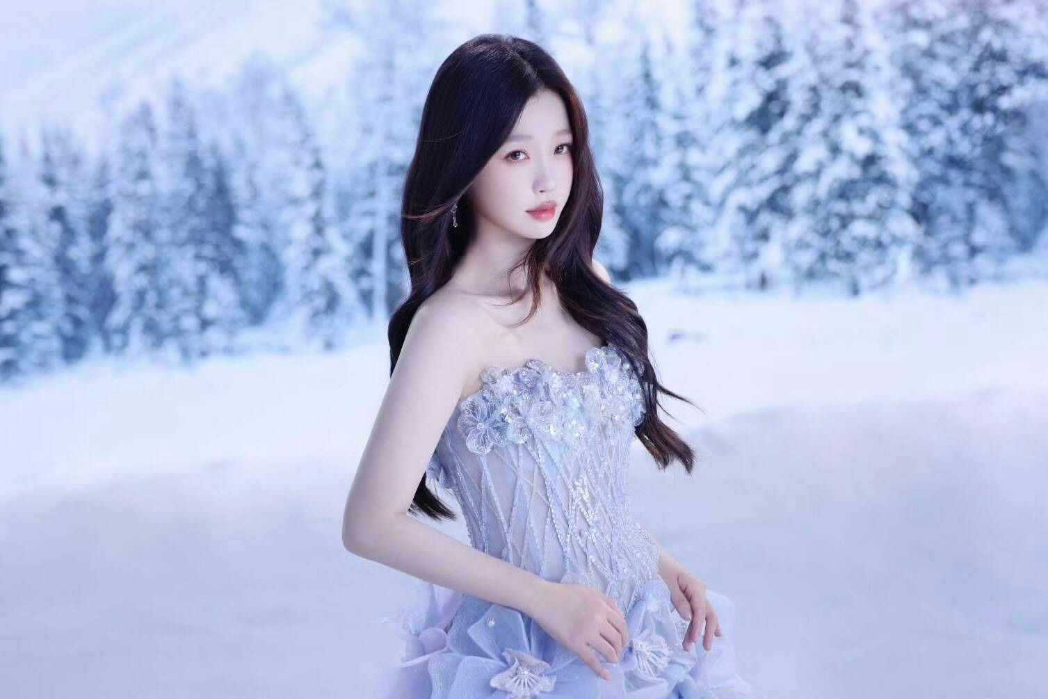 people-1-woman-A-long dark hair-A-strapless light blue gown-A-winter snowy forest background