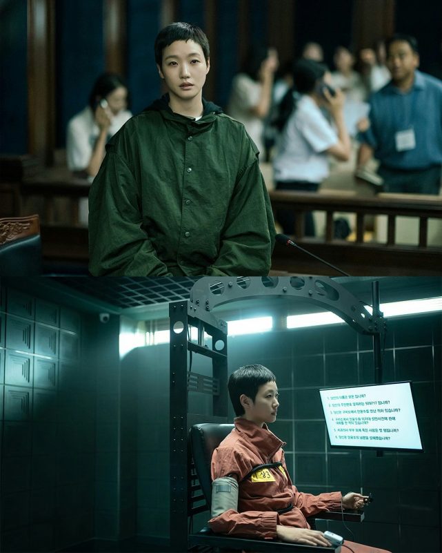 people-woman with short dark hair-A-wearing an oversized dark green hooded jacket-B-sitting in what appears to be a courtroom or public setting-C-in the bottom panel, the same woman with short dark hair is wearing an orange jumpsuit and strapped into a chair with monitoring equipment, facing a screen with Korean text
