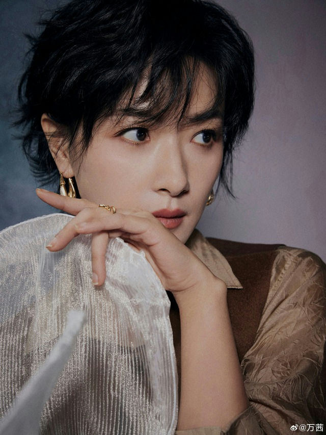 people-Woman-Short black hair-Closeup portrait-Looking away-Wearing gold jewelry-Holding sheer white fabric