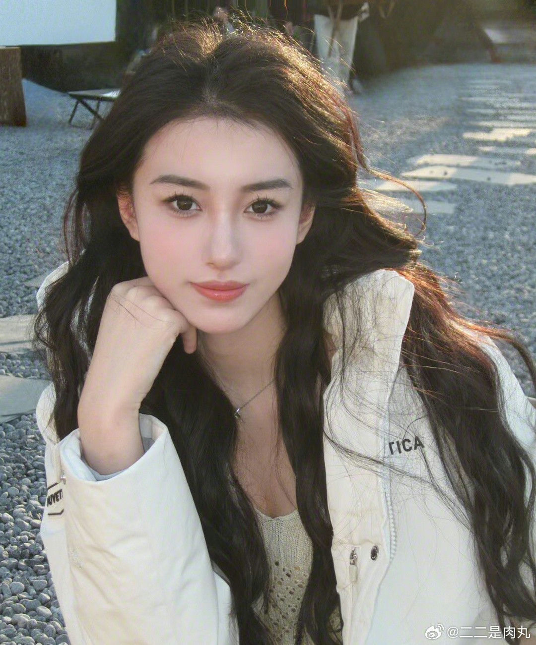 people-Woman-A-long dark hair-A-white jacket-A-posing chin rest