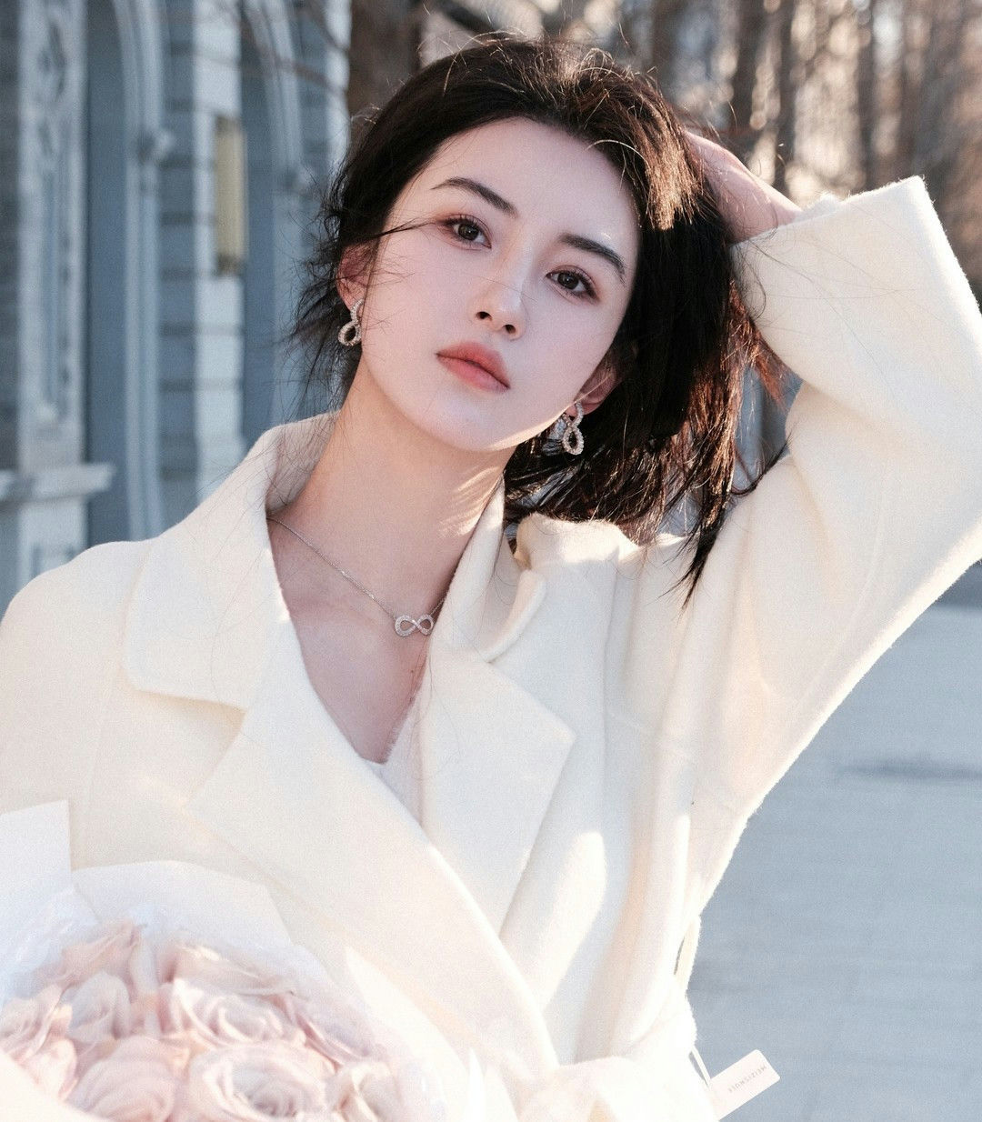 people-woman-A-white coat-B-infinity necklace-C-bouquet of roses