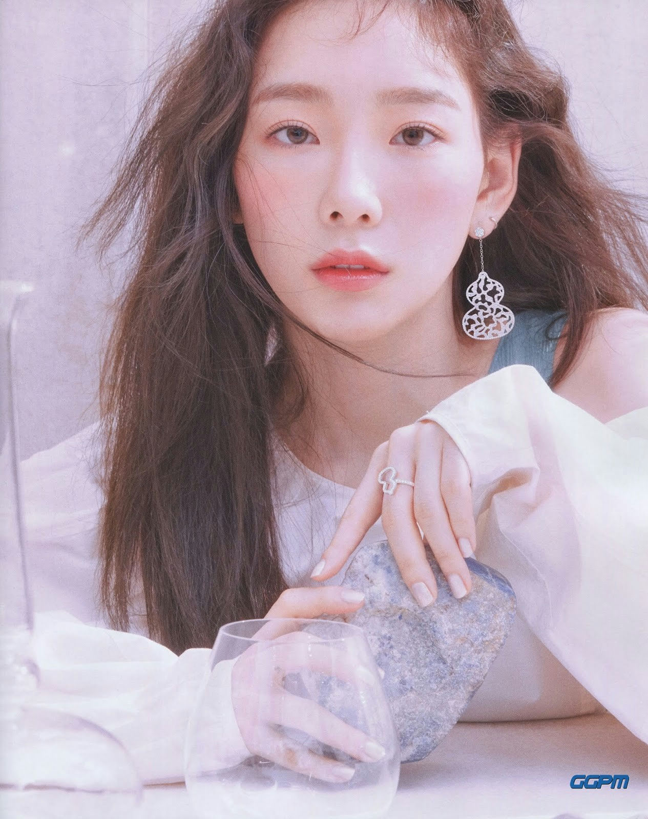 people-Taeyeon-A-close-up-A-long brown hair-A-dangling earring-A-holding stone-A-white sheer top