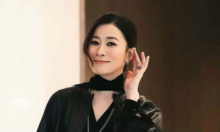 people-woman-smiling-attire-black leather jacket-jewelry-ring and earring-pose-hand near face
