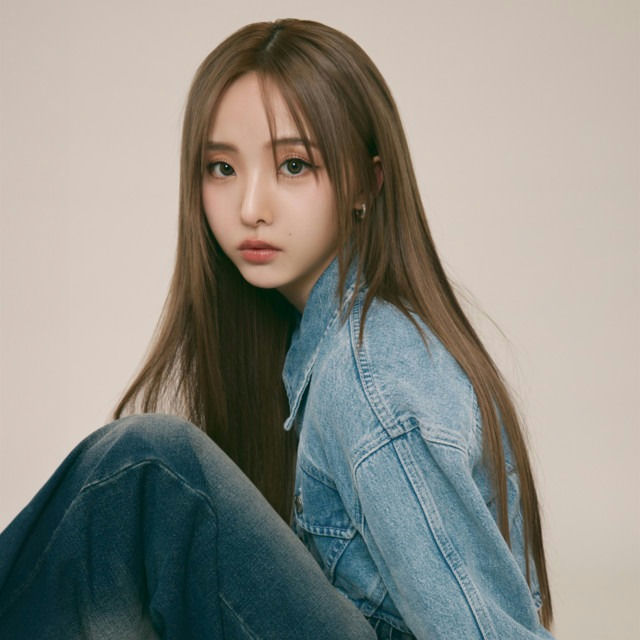 people-young woman-A-long brown hair-A-denim jacket-B-blue jeans-C-indoor portrait