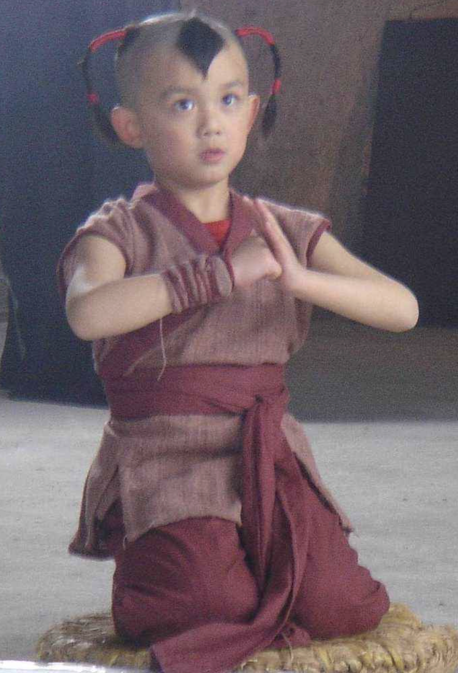 people-young-boy-A-martial-arts-stance-A-traditional-clothing-A-shaved-head-with-pigtails