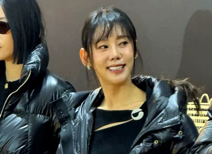 people-woman-smiling-A-black puffer jacket-B-shiny fabric-C-earrings