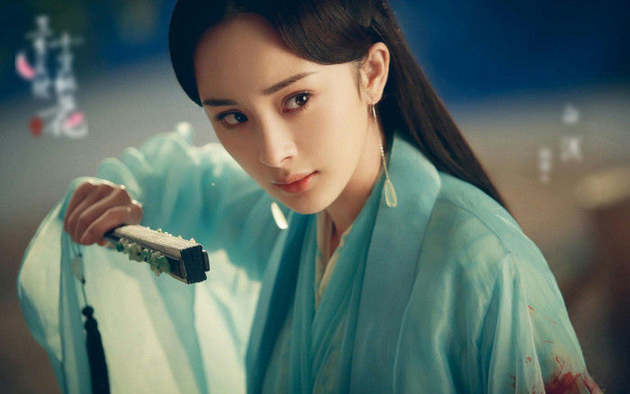 people-female-Chinese actress-A-Yang Mi-A-light blue historical costume-A-holding a closed fan-A-intense expression