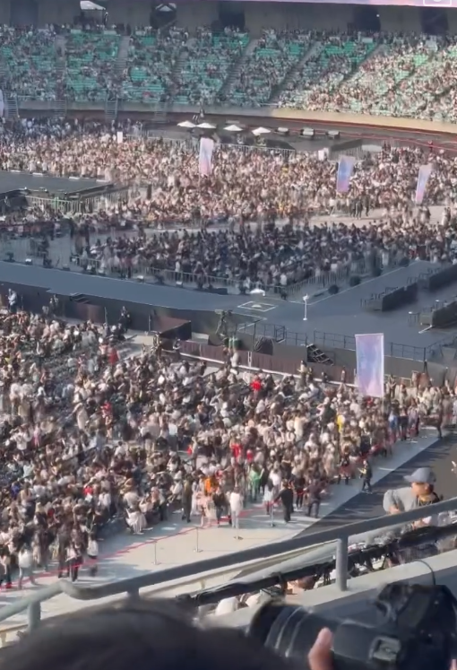 people-Crowd in stadium-A-Seating tiers visible-B-Event in progress-C-Fan recording