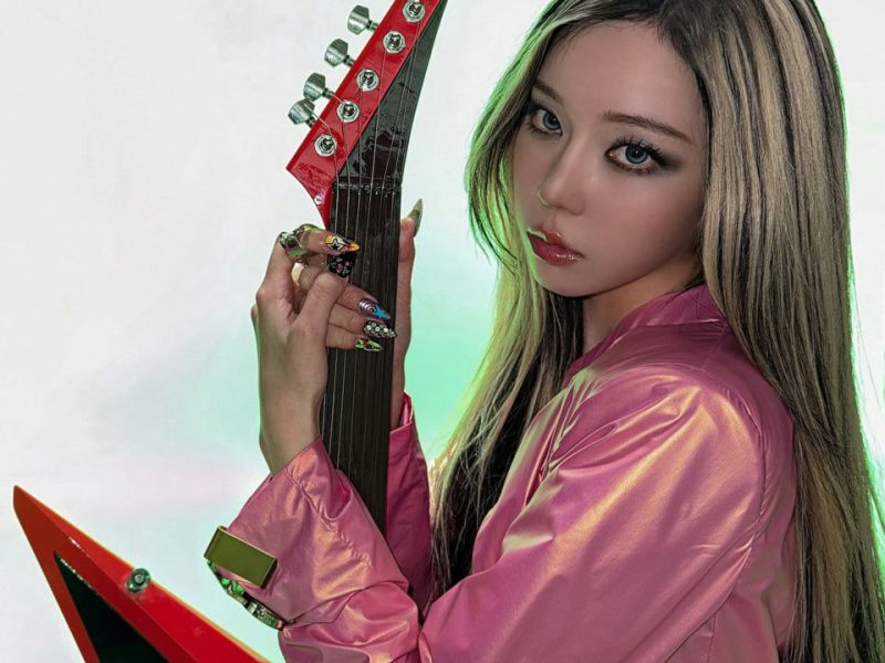 people-woman-A-long hair-A-pink outfit-A-electric guitar-A-dramatic lighting