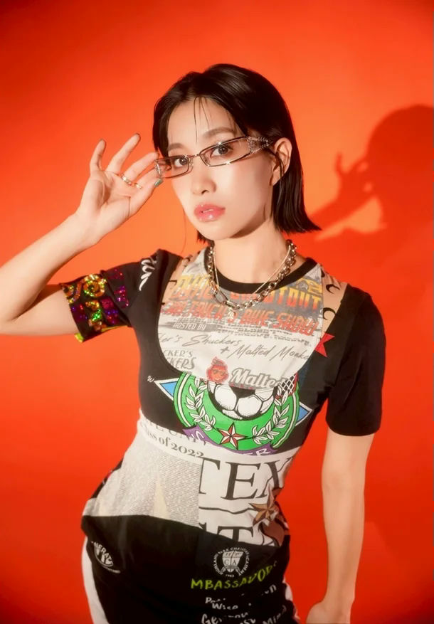 people-Woman-A-short black hair-A-orange background-A-graphic crop top-A-fashion glasses