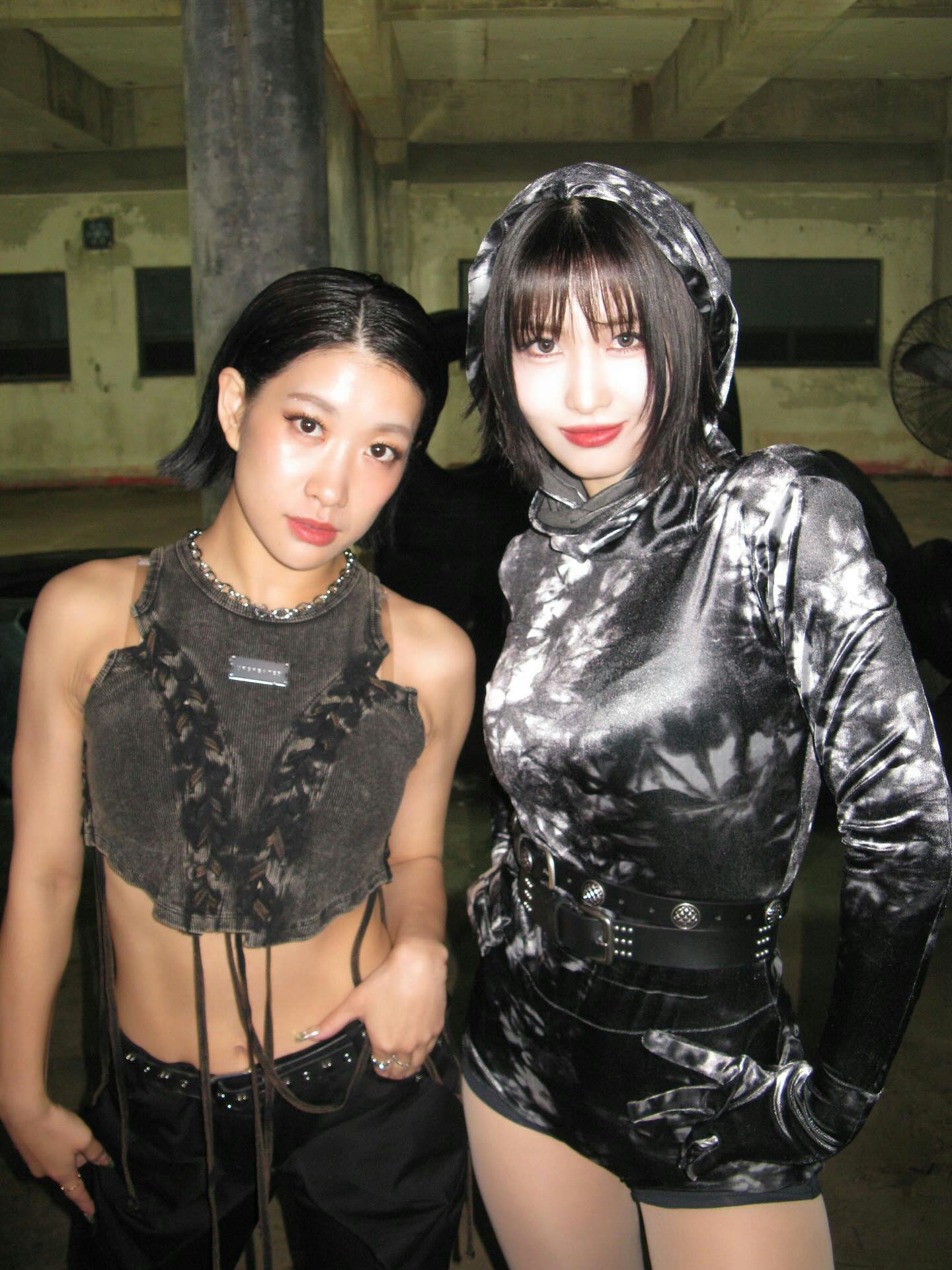 people-Two young women-A-dark edgy fashion-A-indoor setting-A-two people posing-A-cropped tops and shorts-A-dark aesthetic