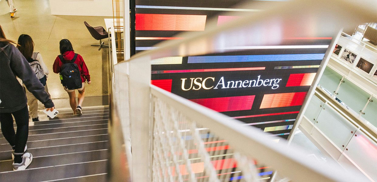 people-Students ascending stairs-A-USC Annenberg digital screen-B-Modern interior architecture-C-Railing detail