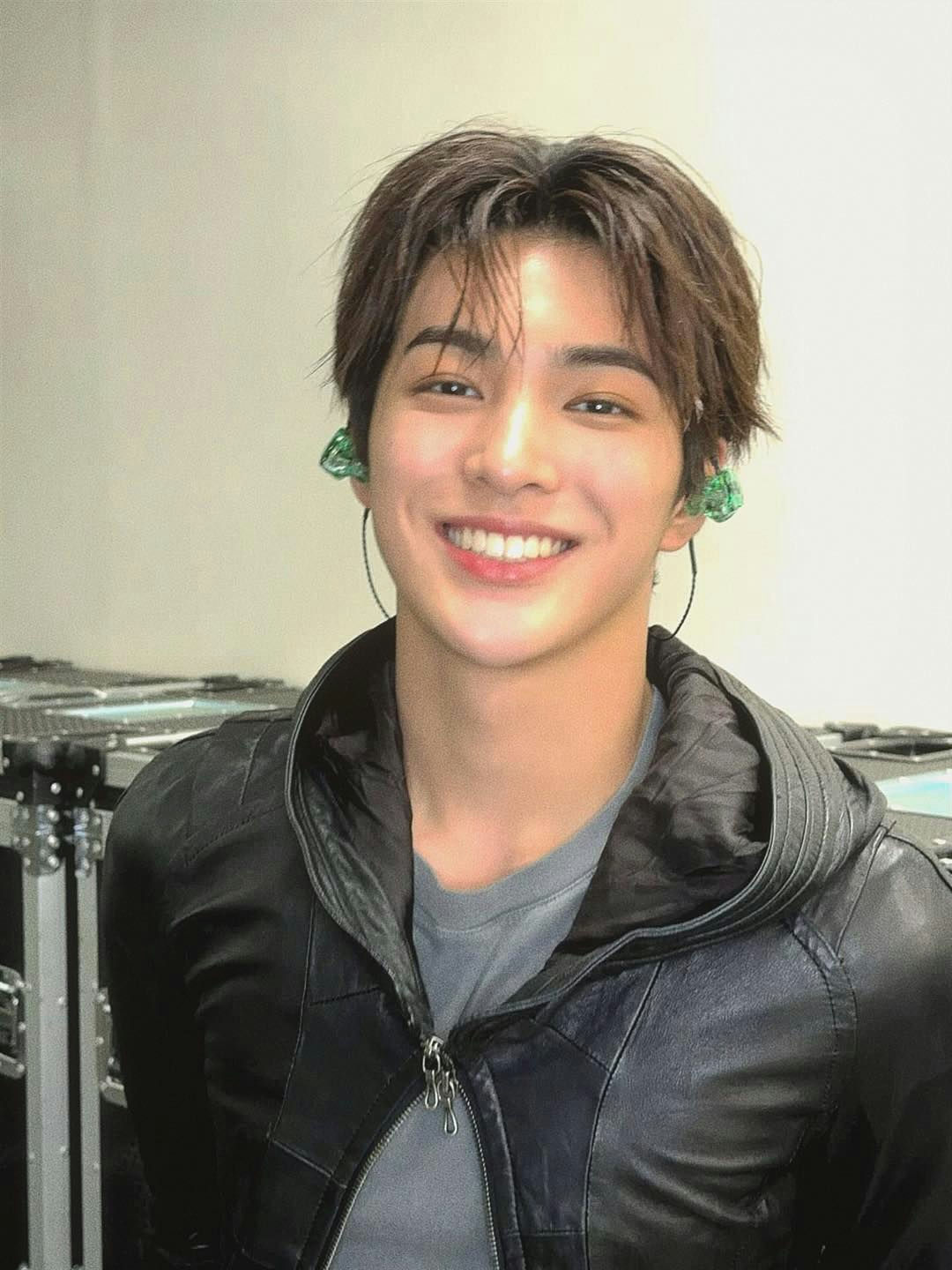 people-A-man-A-smiling-A-brown hair-A-black leather jacket-A-in-ear monitors
