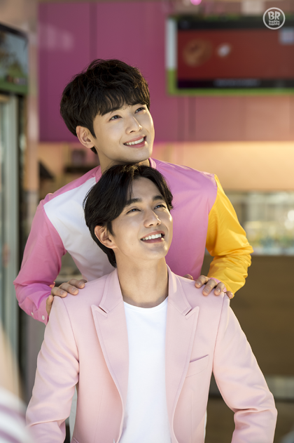 people-two men-smiling-pink outfits-Baskin Robbins logo