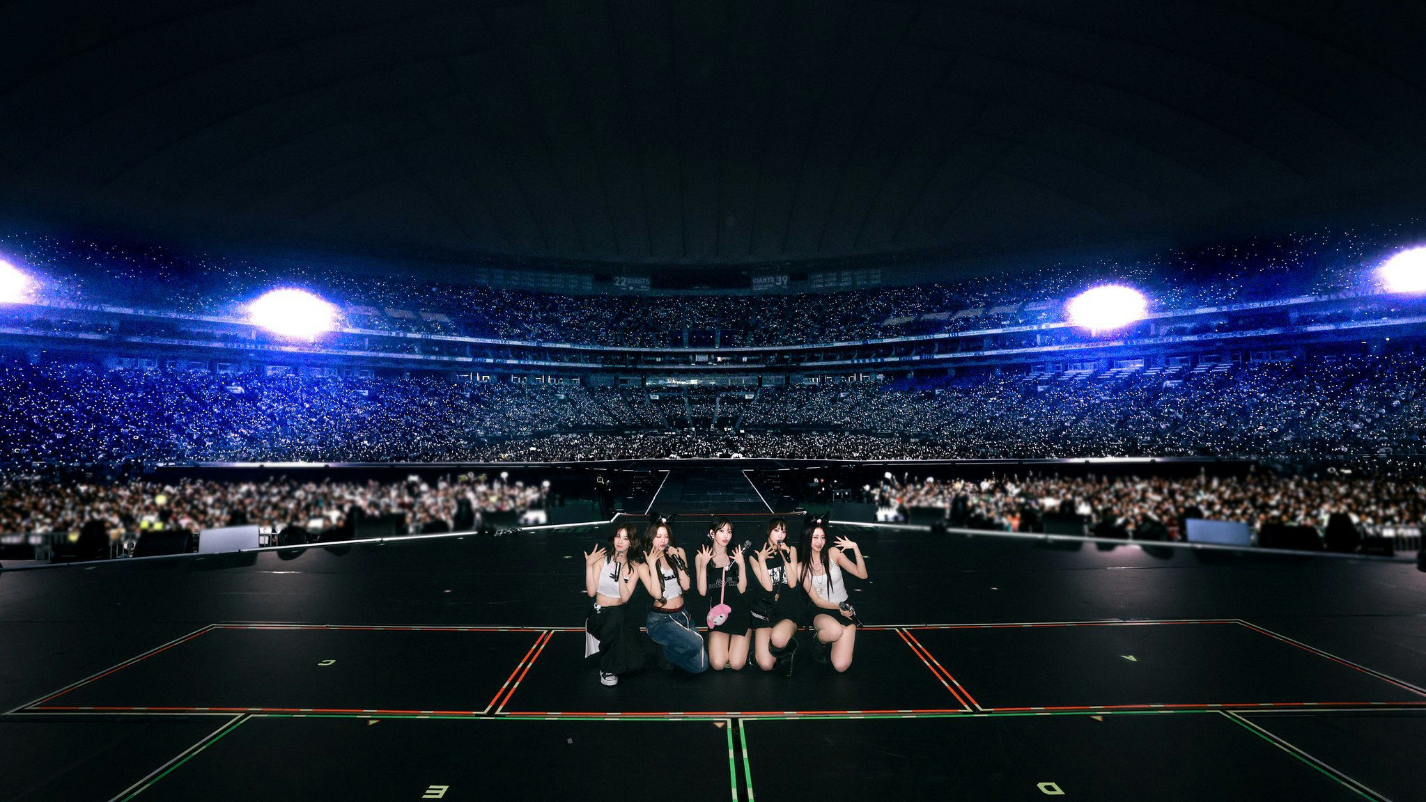 people-Five K-Pop idols-A-stadium concert-B-crowd with lightsticks-C-dark and blue lighting