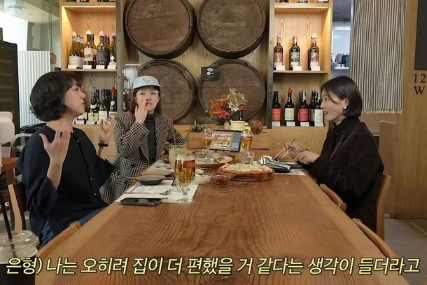 people-three women-A-dining-A-restaurant-A-wine barrels-A-pizza and beer