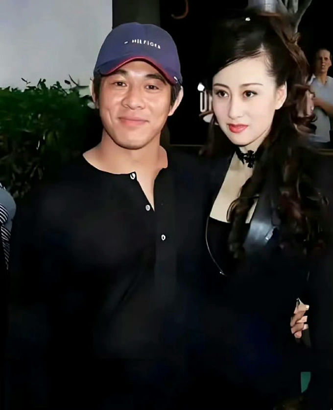 people-Man in black shirt and Tommy Hilfiger cap-A-Woman in black attire-B-Smiling-C-Posing for photo