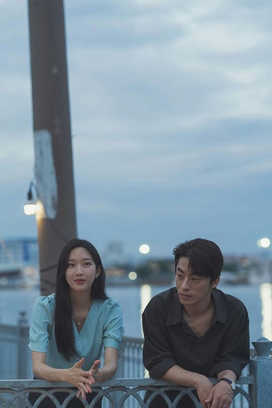 people-woman-leaning-on-railing-man-leaning-on-railing-night-scene