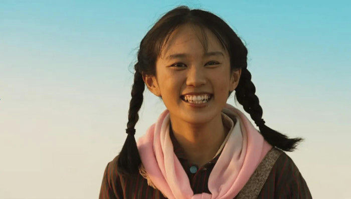 people-young girl-A-pigtails-A-smiling-A-pink scarf-B-outdoors-C