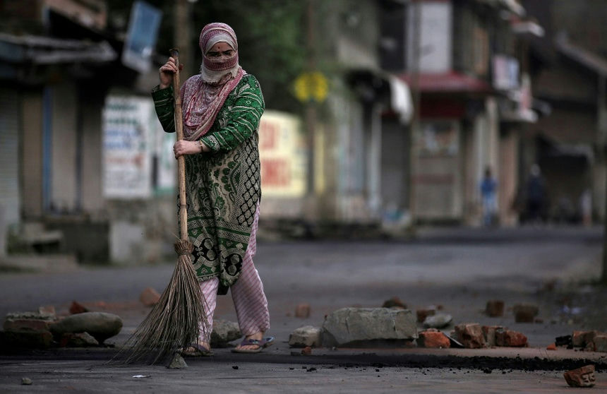 people-A-woman-A-sweeping-A-street-B-brick-debris-C-veiled-face