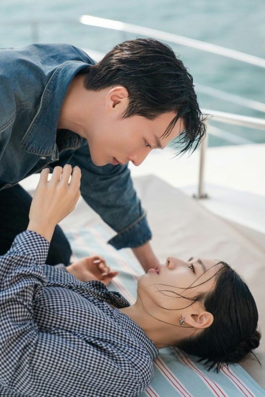 people-Man and Woman-leaning over-A-lying down-B-intense gaze-C-on a boat