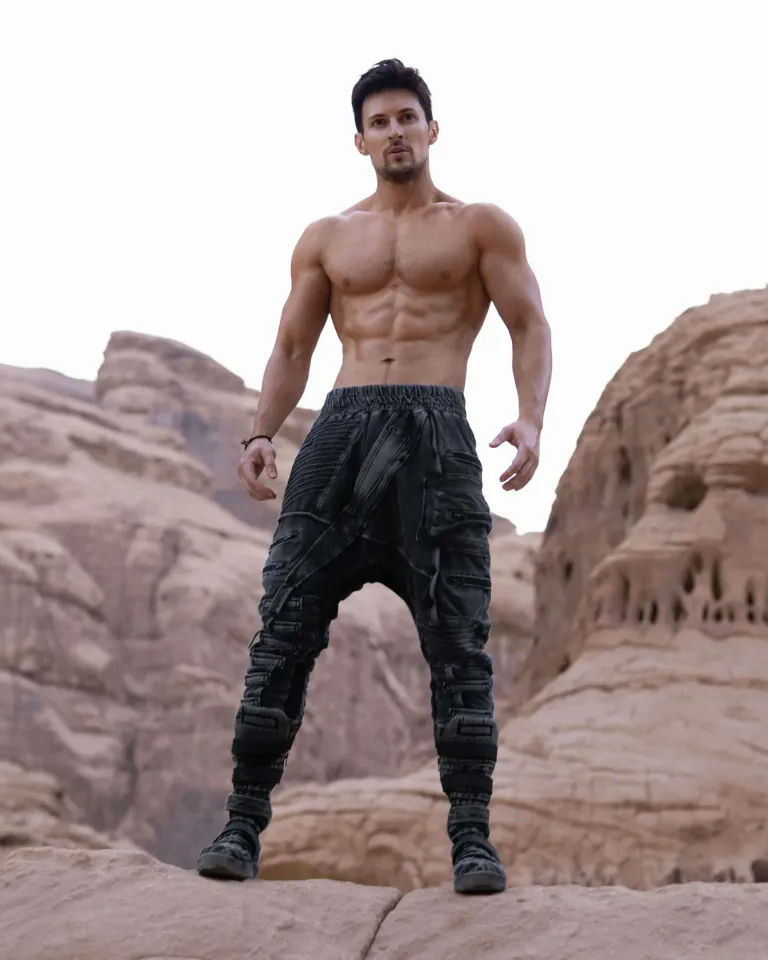 people-Man-A-muscular-A-shirtless-A-standing-B-desert-B-rocky-C-dystopian-pants