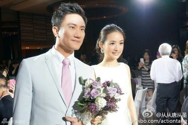 people-A-man in light blue suit-B-woman in white dress-C-wedding/event attendees