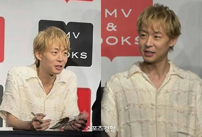 people-man-blond hair-male celebrity-white textured shirt-signing event-MV&BOOKS logo