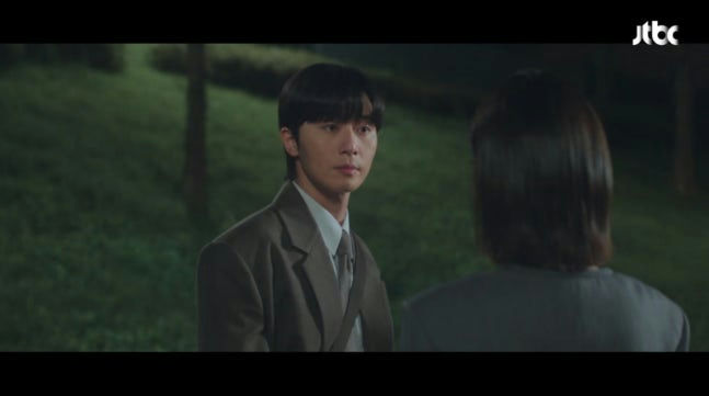 people-man in suit-outdoors at night-woman with back turned-JTBC logo