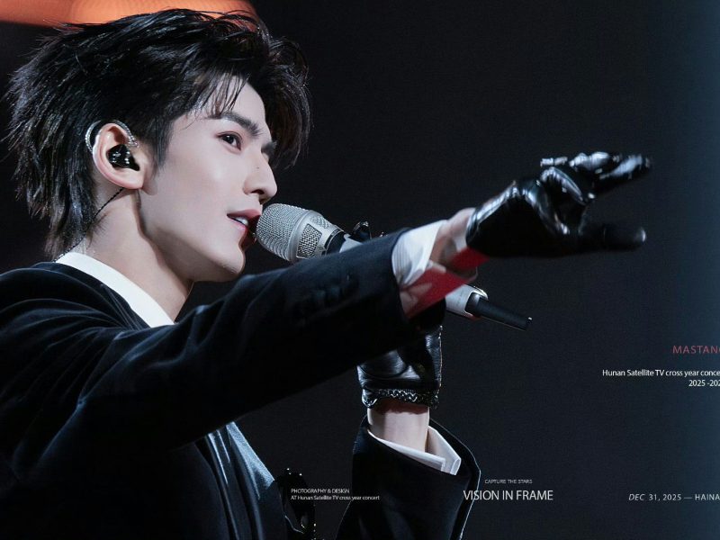 people-A-male singer-A-performing-B-in-ear-monitor-B-black-suit-C-gloved-hand