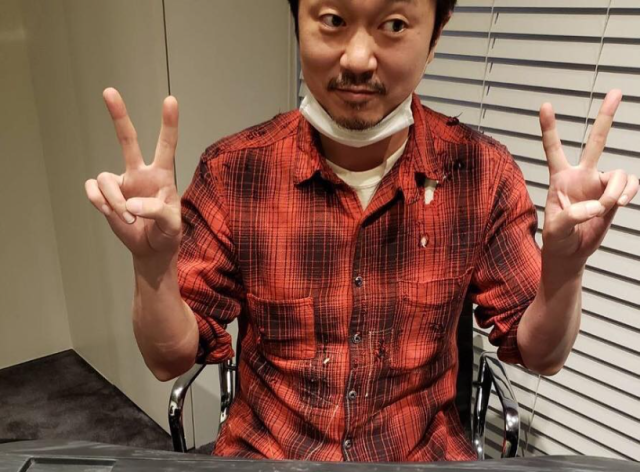 people-A-man-A-peace sign-B-red plaid shirt-C-mask around neck
