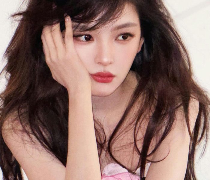 people-Young East Asian Woman-A-Long Dark Wavy Hair-A-Leaning Head on Hand-B-Red Lipstick-C-Pink Clothing