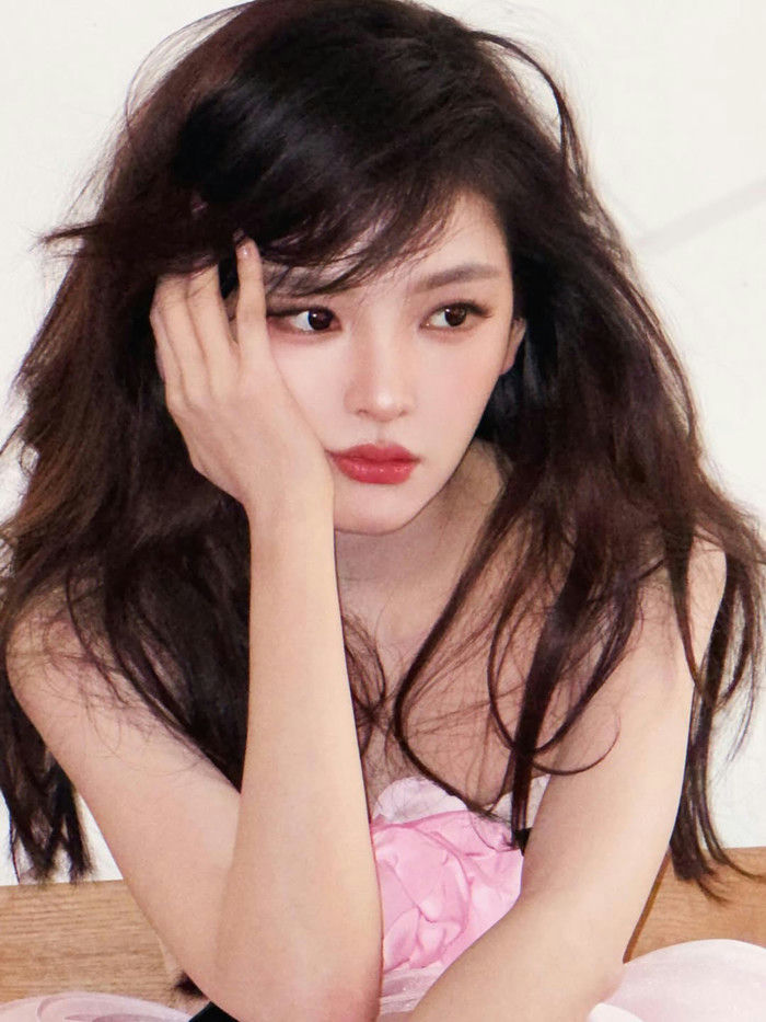 people-Young East Asian Woman-A-Long Dark Wavy Hair-A-Leaning Head on Hand-B-Red Lipstick-C-Pink Clothing