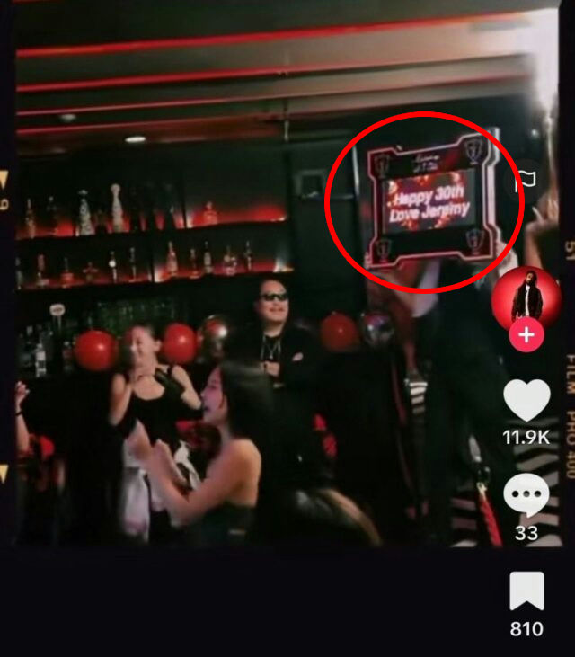 people-birthday celebration-Jerminy-holding sign-red balloons-bar setting-TikTok interface