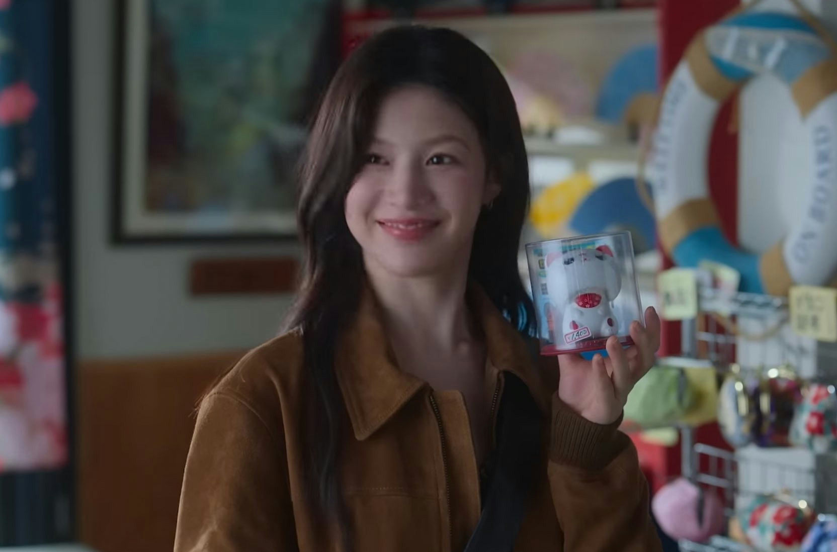 people-Jung Hae-in (as supporting character)-smiling-holding a toy-brown jacket-in a shop