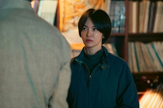 Korean Actress Song Hye-kyo-A-short black bob haircut-A-dark teal jacket-A-serious expression-A-bookshelves in the background